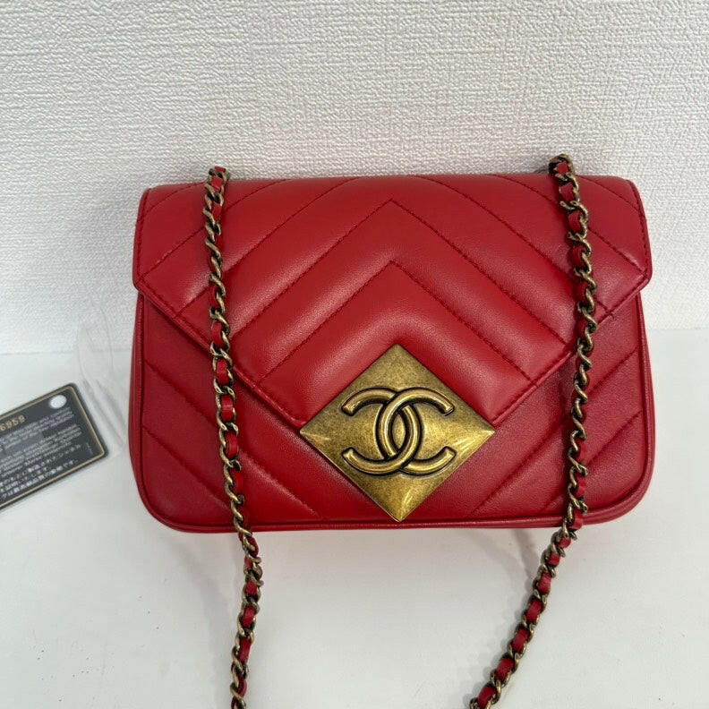 Chanel Red Lambskin Mini Single Flap Bag with Gold Chain and CC Logo.