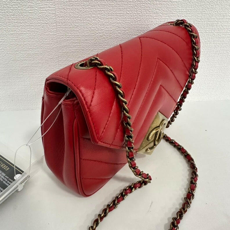 Chanel Red Lambskin Mini Single Flap Bag with Gold Chain and CC Logo.