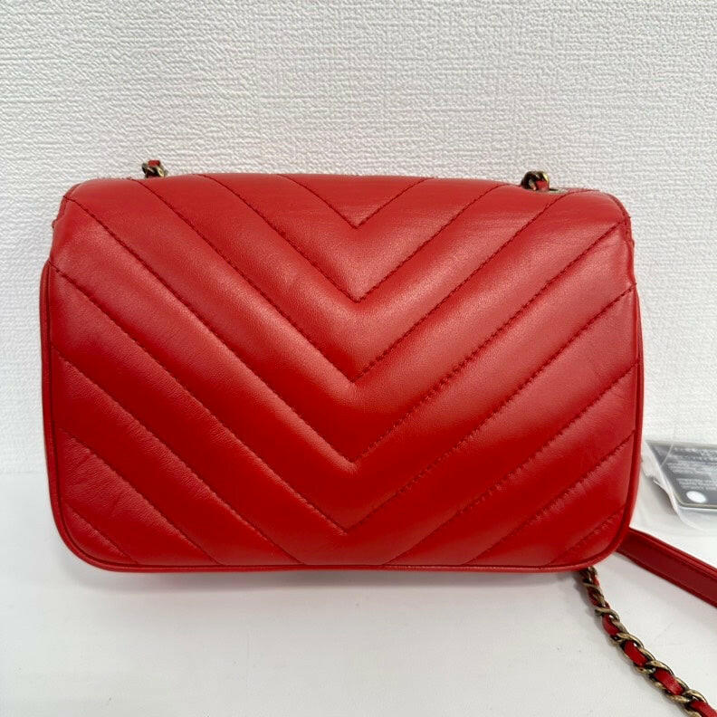 Chanel Red Lambskin Mini Single Flap Bag with Gold Chain and CC Logo.