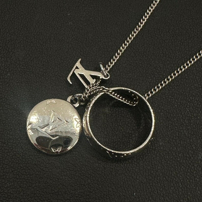 Louis Vuitton Silver Pendant Necklace with Monogram Charm and Ring Charm.