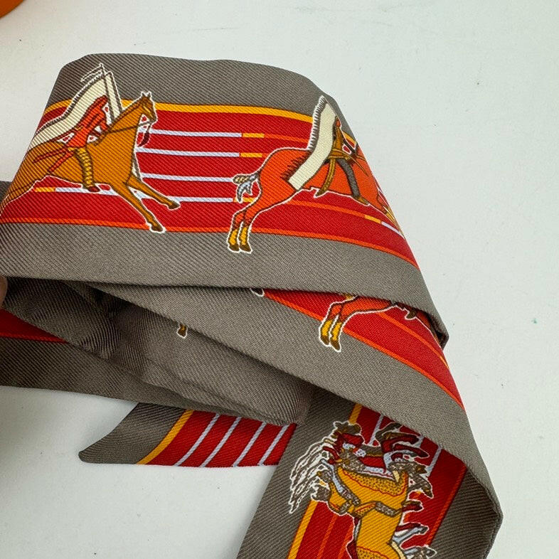 Hermès Gray Twilly Scarf with Orange and Red Equestrian Print 32x2 Inches.