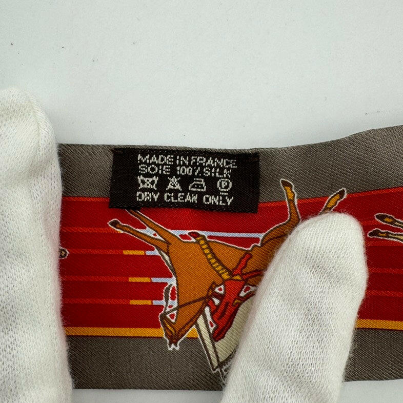 Hermès Silk Twilly in Red and Grey with Reindeer Design, 34 x 8 cm.