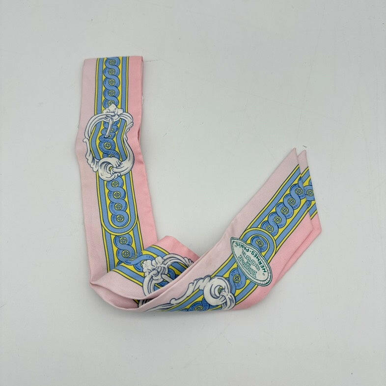 Hermès Twilly Silk Scarf Pink, Blue, and Yellow Pattern 32x2 Inches.